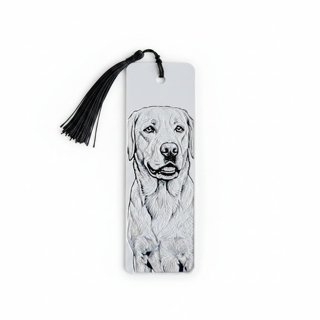 A white rectangular bookmark with a black tassel, featuring a detailed black and white sketch of a Labrador Retriever on the front, set against a light beige textured background.