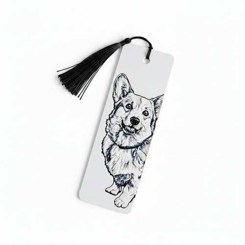 A white rectangular bookmark with a black tassel, featuring a black line art sketch of a corgi dog on the front, photographed against a light beige textured background.