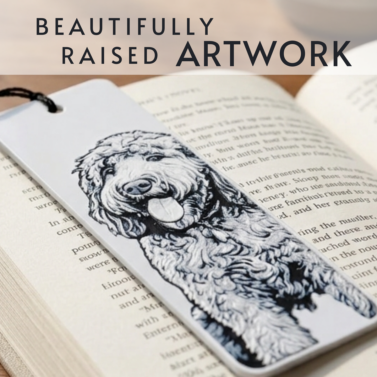 A rectangular bookmark or page marker featuring a detailed black-and-white sketch of a fluffy dog, placed on open book pages. Large text at the top reads 'BEAUTIFULLY RAISED ARTWORK'.
